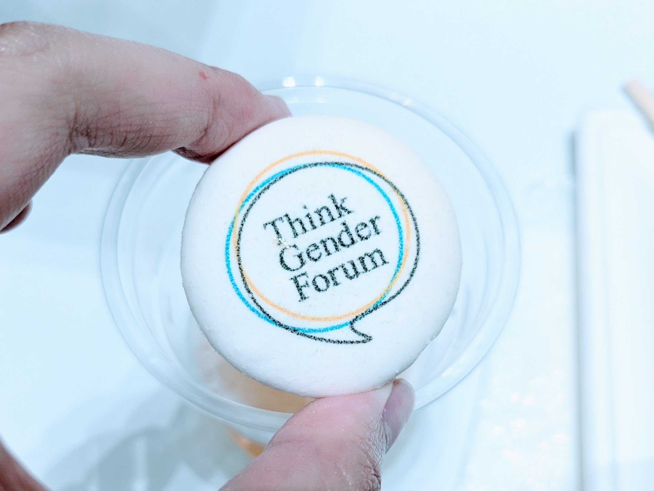 a macaron printed with the Think Gender Forum logo